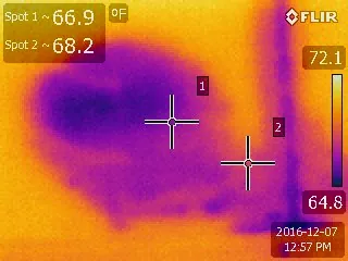 An infrared image showing a cool moisture plume spreading across a ceiling