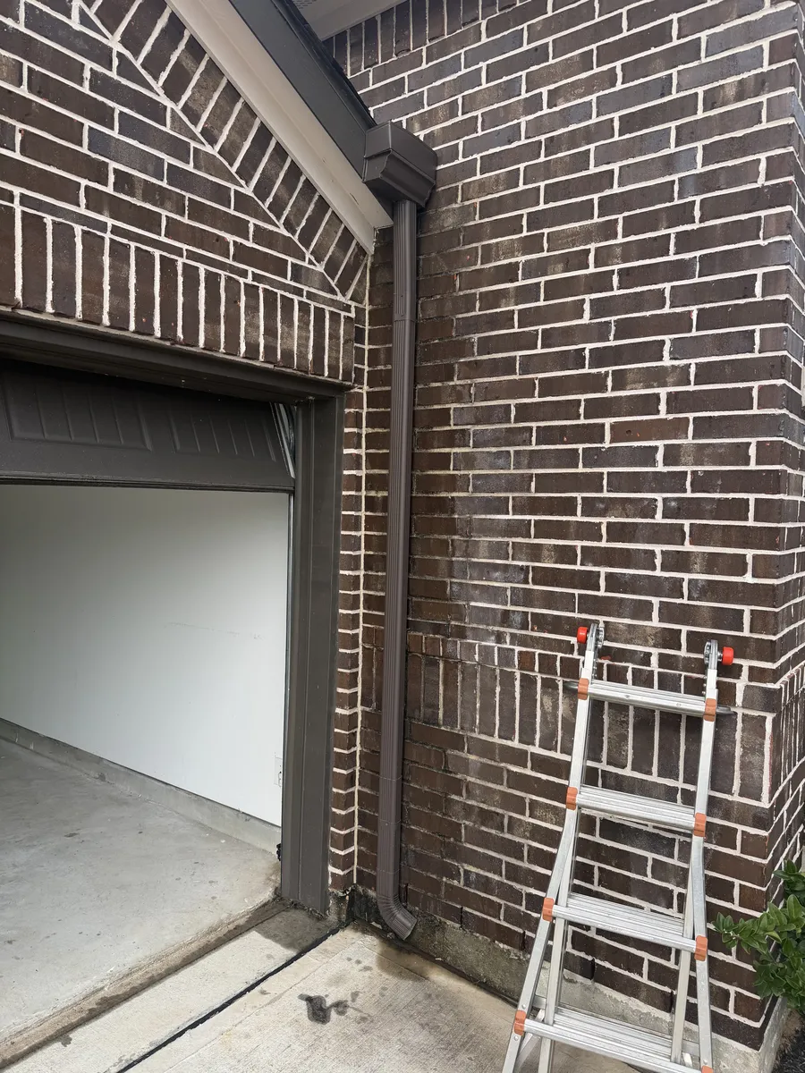 The brick exterior and garage opening of a new Houston home during a phase inspection